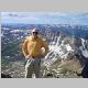 Brian on the summit of Mt Sneffels, Wilson lake, Blue Lakes Pass, and Gilpin Peak in view 